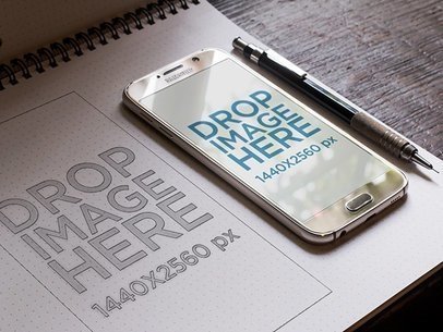 Samsung Galaxy S6 Mockup Lying on Top of a Wireframe Notebook 7056